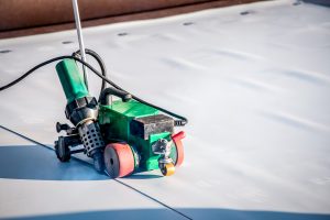 Construction device for installing waterproofing materials on the roof. Installation of waterproofing at a construction site. Protection of the roof of the building from water leakage.