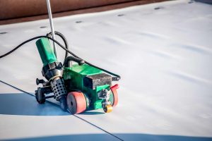 Construction device for installing waterproofing materials on the roof. Installation of waterproofing at a construction site. Protection of the roof of the building from water leakage.